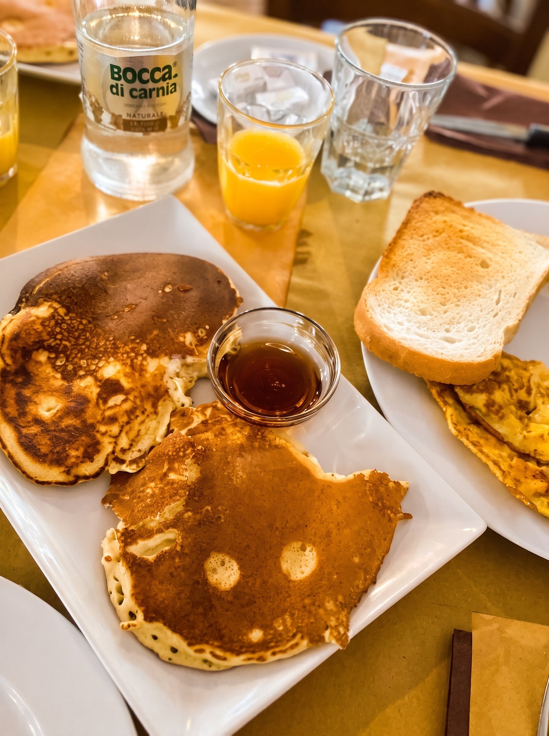 Stack of pancakes with maple syrup and coffee